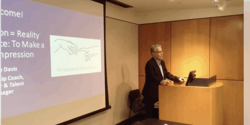 A man presenting a lecture with a projection of Michelangelo's Creation of Adam.