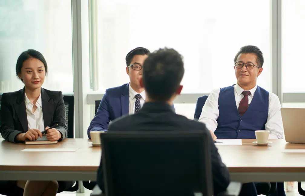 Business professionals in a formal interview setting.